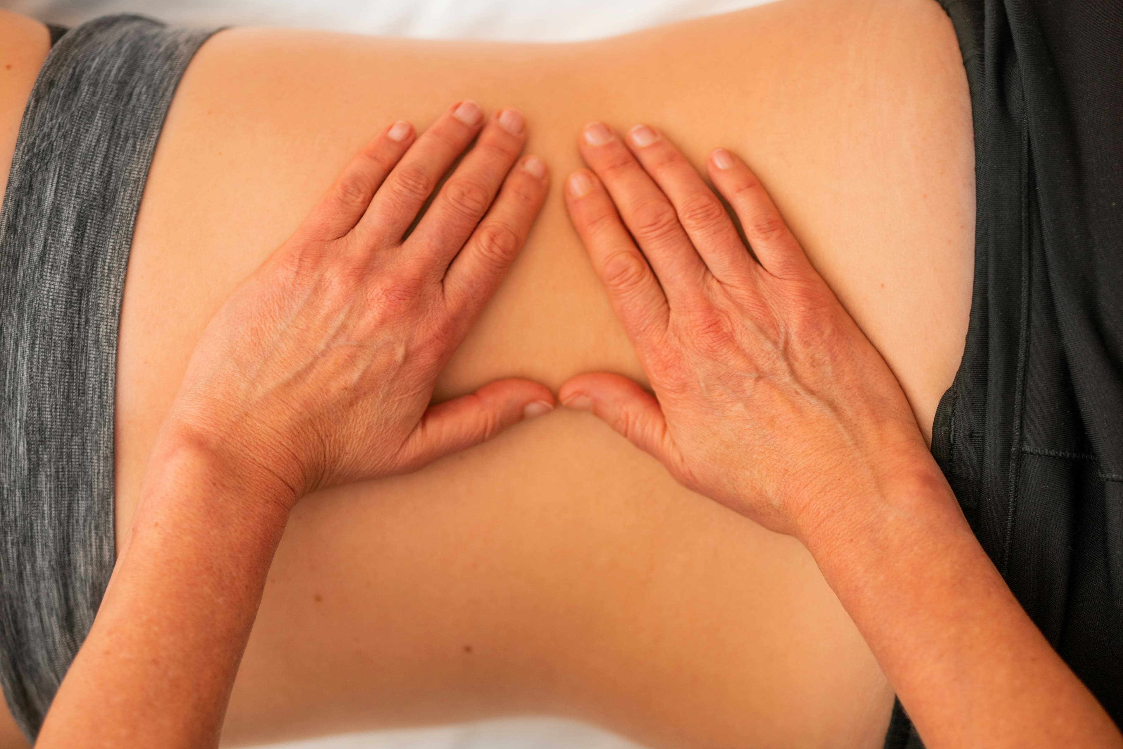 A therapist applying therapeutic massage techniques to a client
